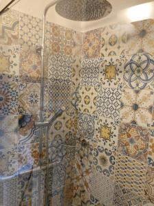 a bathroom with a shower with tiles on the wall at Corte del Catria in Chiaserna