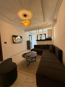 a living room with a couch and a table at Appartement T2- Ain zaghouen in Sidi Daoud