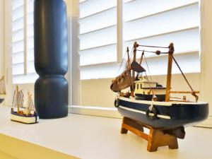 a toy boat sitting on a table in a room at Union Street in Kirkcudbright