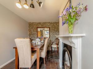 a dining room with a table and a fireplace at West Llwyn - Uk41757 in Rhyd Owen