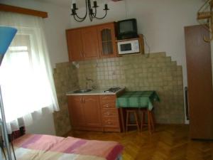a small kitchen with a sink and a microwave at Sóstó Apartman in Siófok +10 photos