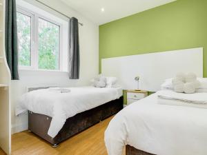 a bedroom with two beds and a window at Hare Lodge - Uk30604 in Pidley