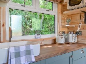 a kitchen with a sink and a window at Ewe Lodge - Uk48824 in Kirby Misperton
