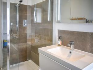 a bathroom with a sink and a shower at Beach View in Woolacombe +1 photo