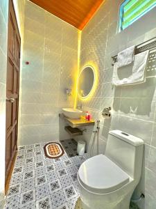 a bathroom with a toilet and a sink at Tepak Nusuk Private Pool Homestay 5 Bedrooms 4 Bathrooms in Kota Bharu