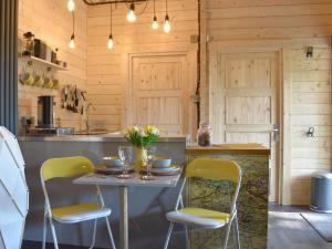 a kitchen with a table and two chairs at Poppy Lodge in Minster