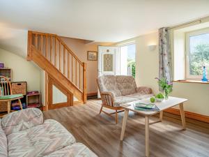 a living room with a couch and a table at Trelawney Cottage in Charlestown