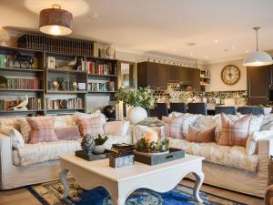 a living room with couches and a table at The Old Stables in Howwood