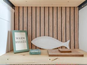 a white shark sitting on a table next to a book at Primrose Cottage in Teignmouth