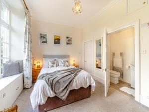a bedroom with a bed and a bathroom at Crag View in Ambleside