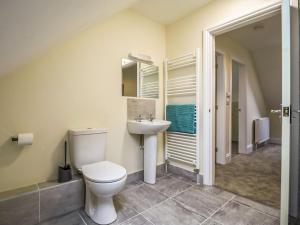 a bathroom with a toilet and a sink at 1 Dawson Court - Uk33410 in Mablethorpe