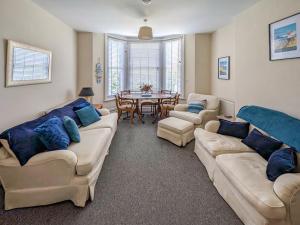 a living room with two couches and a table at Viking Bay Apartment in Broadstairs