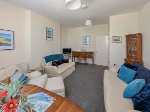 a living room with two couches and a table at Viking Bay Apartment in Broadstairs