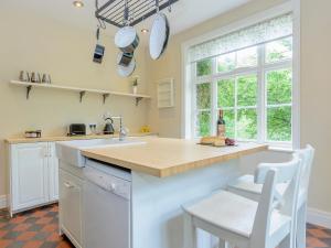 a kitchen with a counter and a sink and a window at Station House in Millers Dale