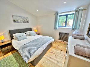 a bedroom with a large bed and a window at Orion - Ukc3210 in Newbridge