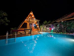 a house with a swimming pool at night at Senu Lee Cabana in Galle