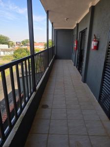 a corridor of a building with a balcony at Mirage grand vista in Franca