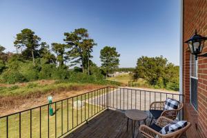 a balcony with two chairs and a table and a fence at Classic City Quarters in Athens