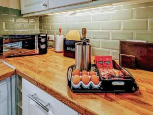 a kitchen counter with eggs and a blender on it at May Cottage in Hackness