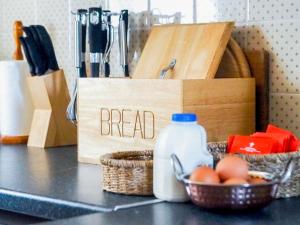 a sign that says bread next to a basket of eggs at May Cottage in Hackness