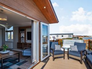 a balcony with a view of a living room at Coastal Retreat - Uk37722 in Ingoldmells