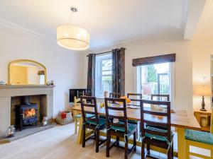 a dining room with a table and a fireplace at Temple House in West Burton +32 photos