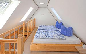 a bedroom with a bed with blue pillows at Ferienwohnung Malchow in Malchow +9 photos