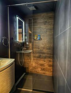 a bathroom with a shower and a sink and a mirror at Adriana near the Beach & 5 min from the Airport in Kaštela