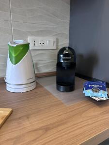 a coffee maker sitting on top of a counter next to a blender at Pompei Regio in Pompei