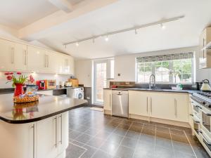a kitchen with white cabinets and a counter top at Northstead Lodge in Flamborough +24 photos