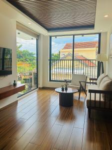a living room with a couch and a table at Glosshomes in Hoi An