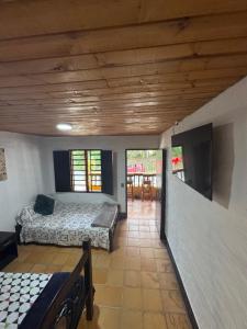 a bedroom with two beds and a flat screen tv at Villa Camila in Trujillo +10 photos