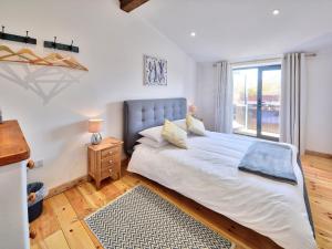 a bedroom with a large bed and a window at Rondo - Ukc3211 in Newbridge