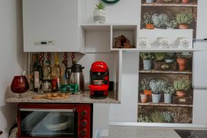 a kitchen with a red microwave in a room at Good Vibes Studio in Bistriţa