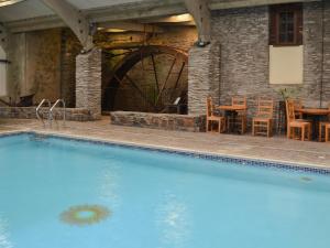a swimming pool in a building with a table and chairs at Lee Studio - Ukc3372 in West Down +13 photos