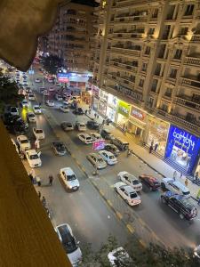 a busy city street at night with cars parked at 18B Shehb Apartment Hotel in Giza