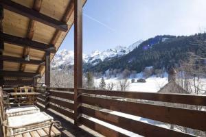 a porch with a view of a snowy mountain at Chalet le Findri in Le Fernuy