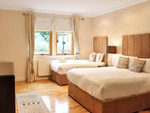a bedroom with two beds and a window at Family Lodge No 2 The Place Downstairs - Uk45691 in Pitlochry