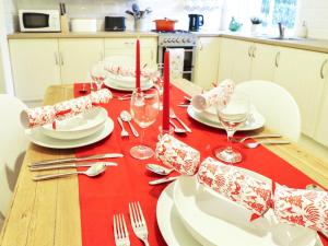 a table with a red table cloth with a cake on it at Union Street in Kirkcudbright +16 photos