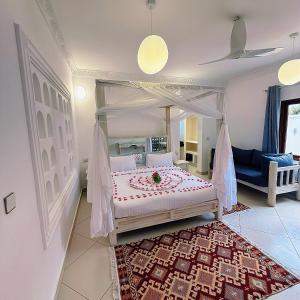 a bedroom with a canopy bed with a rug at Jumeirah Malindi Hotel in Malindi