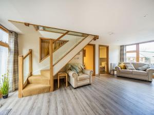 a living room with a staircase and a couch at Horsecroft - Uk37462 in Dorstone