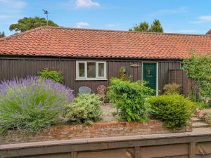 a house with an orange roof and some plants at Pinewood - E3077 in Thorpe Market +2 photos