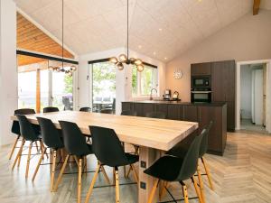 a kitchen and dining room with a wooden table and chairs at 5 star holiday home in Millinge in Millinge