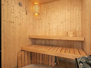 a wooden sauna with a wooden bench in it at 5 star holiday home in Millinge in Millinge