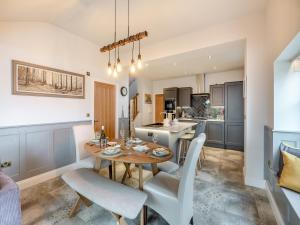 a kitchen and dining room with a table and chairs at Foreman's Cottage in Skidby