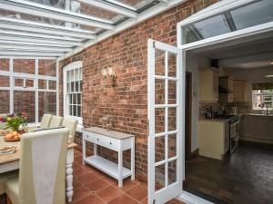a kitchen and dining room with a brick wall at Home Farm House in Dorrington +32 photos