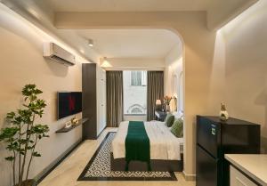 a hotel room with a bed and a window at Secret Garden Hotel Bình Thạnh in Ho Chi Minh City