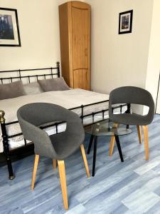 a bedroom with a bed with a chair and a table at App 255Haus 6 in Dierhagen