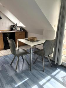 a kitchen with a table and chairs in a room at App 255Haus 6 in Dierhagen