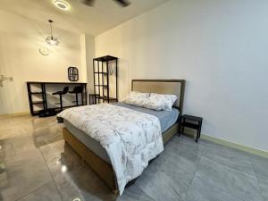 a bedroom with a bed and a desk at Imperio Studio in Malacca